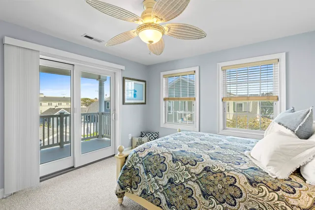 a spacious bedroom with a large bed and a chandelier