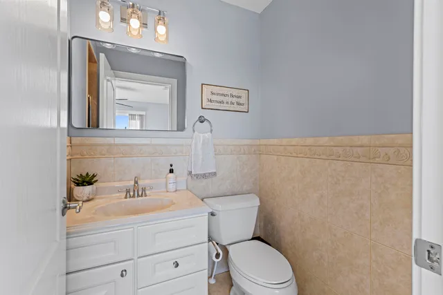 a bathroom with a toilet a sink and mirror