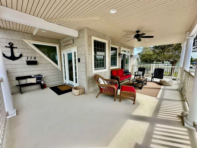 a building outdoor space with patio furniture and potted plants