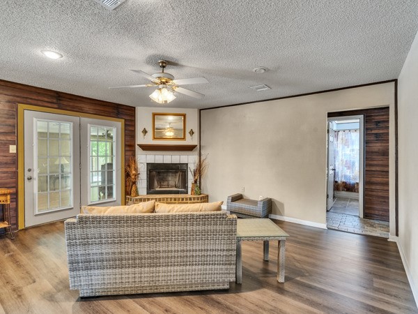 634 Bright Penny Lane Houston, TX 77015 - Photo 11 of 24 a living room with furniture a fireplace and a ceiling fan