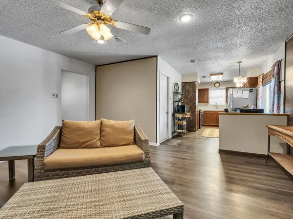 a living room with furniture and kitchen view