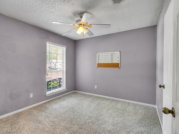 634 Bright Penny Lane Houston, TX 77015 - Photo 23 of 24 an empty room with windows and chandelier fan