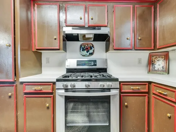 a stove top oven sitting inside of a kitchen