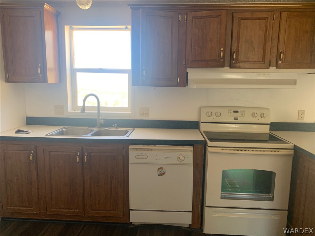4745 Smoketree Road Golden Valley, AZ 86413 - Photo 12 of 33 a kitchen with a sink stove and cabinets