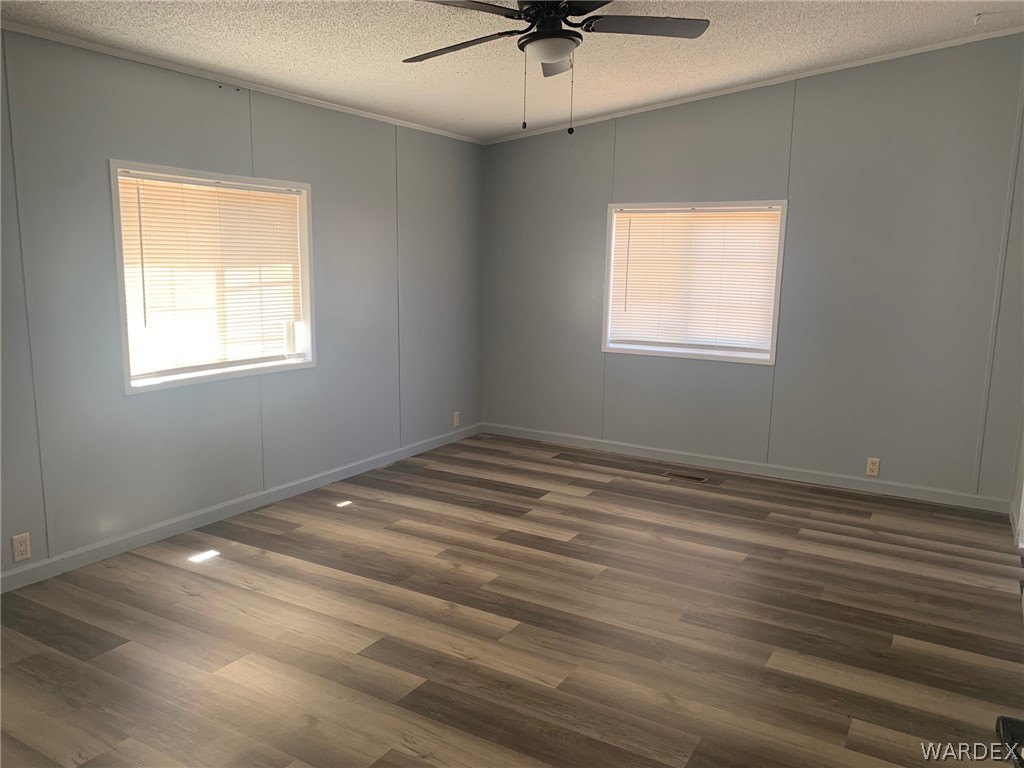 4745 Smoketree Road Golden Valley, AZ 86413 - Photo 15 of 33 a view of empty room with wooden floor and fan