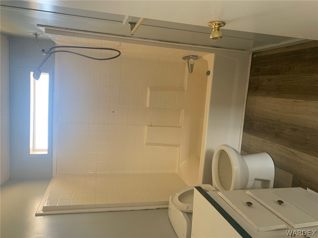 4745 Smoketree Road Golden Valley, AZ 86413 - Photo 18 of 33 a bathroom with a bathtub shower sink vanity and a toilet
