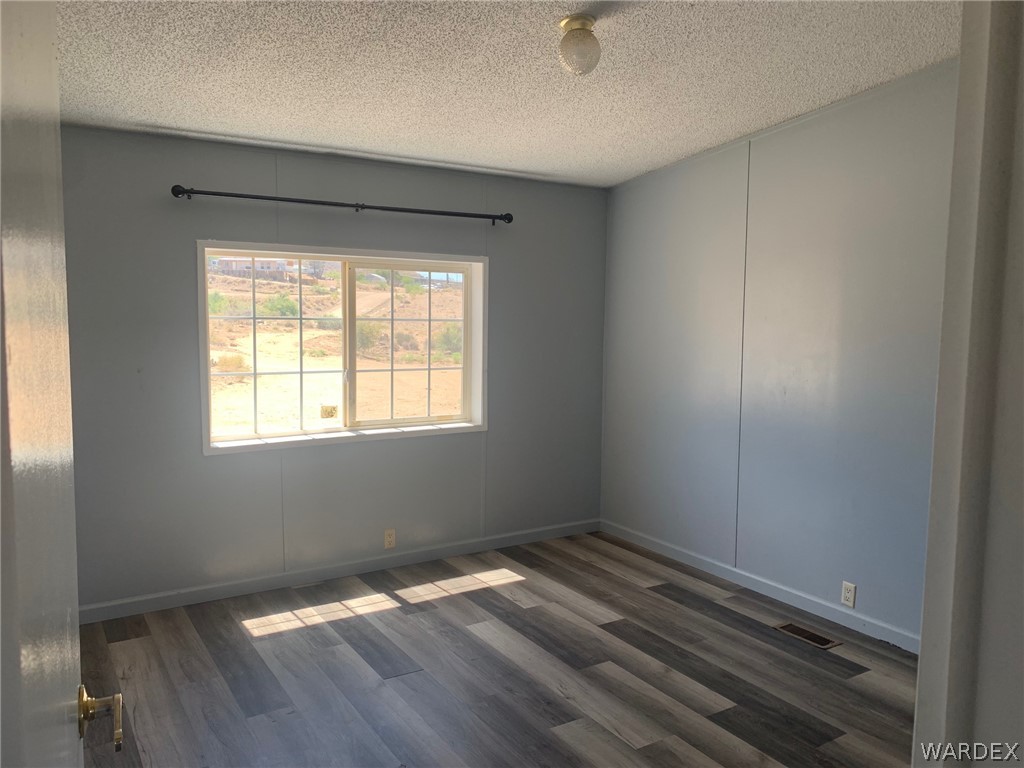 4745 Smoketree Road Golden Valley, AZ 86413 - Photo 21 of 33 a view of wooden floor and windows in a room
