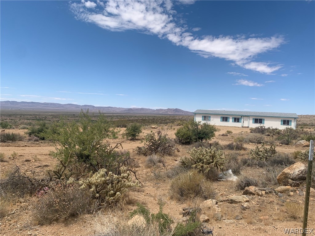 4745 Smoketree Road Golden Valley, AZ 86413 - Photo 3 of 33 a view of a big yard next to a building