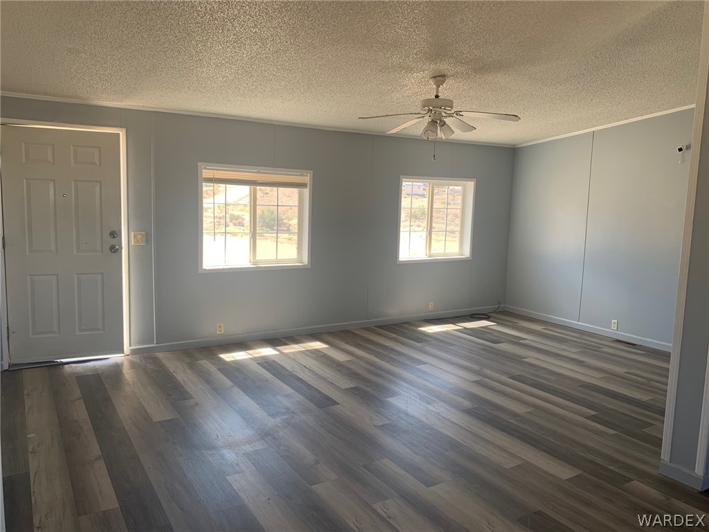 4745 Smoketree Road Golden Valley, AZ 86413 - Photo 4 of 33 a view of an empty room with wooden floor and a window