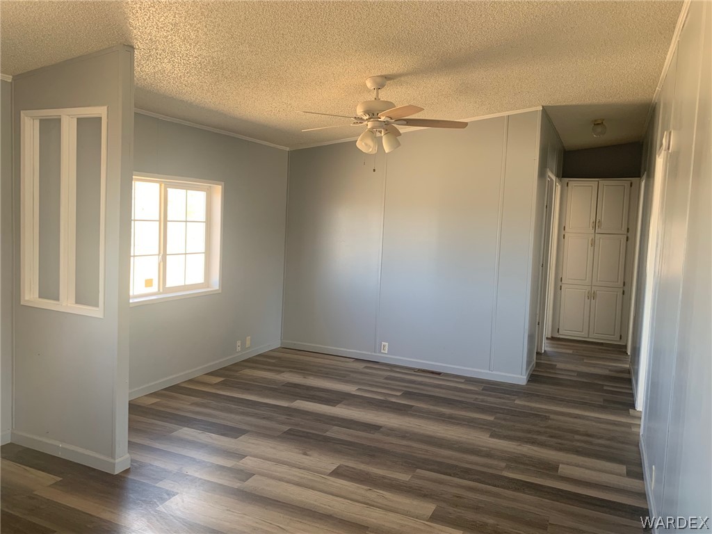 4745 Smoketree Road Golden Valley, AZ 86413 - Photo 6 of 33 a view of an empty room with wooden floor and a window