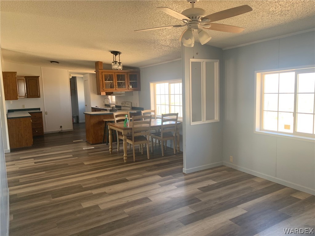 4745 Smoketree Road Golden Valley, AZ 86413 - Photo 7 of 33 a view of a dining room with furniture window and wooden floor