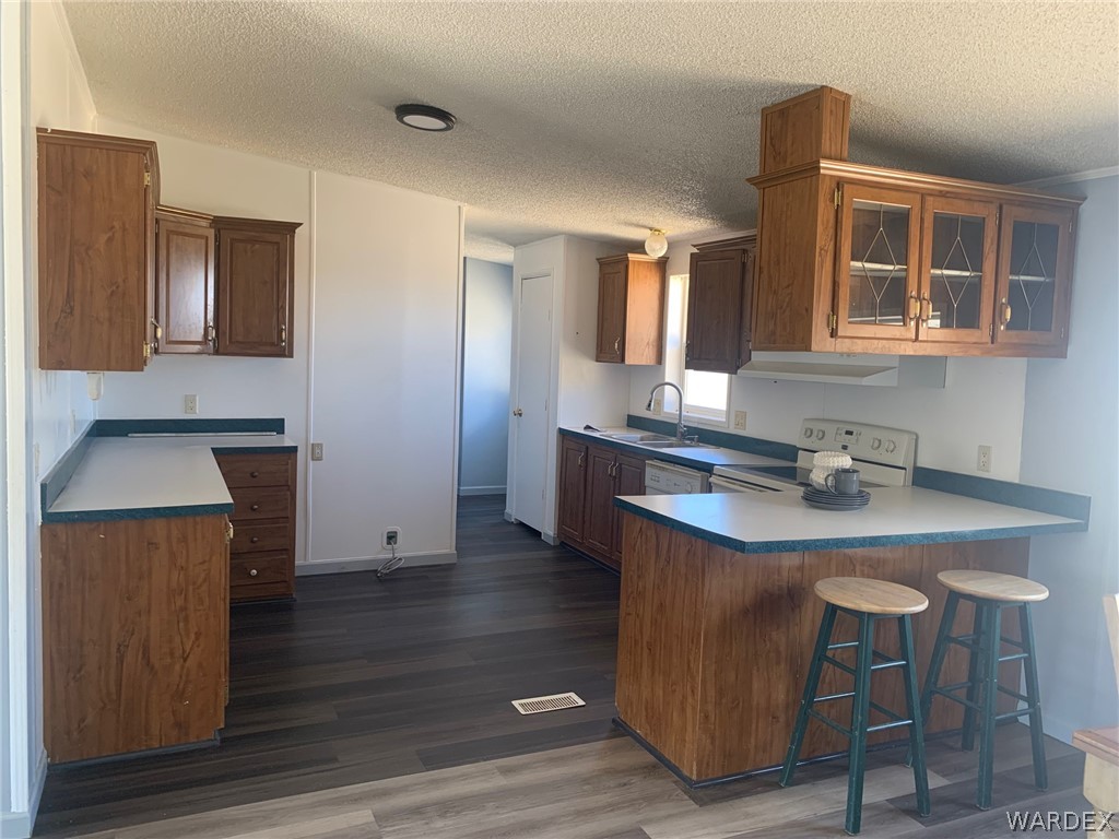 4745 Smoketree Road Golden Valley, AZ 86413 - Photo 8 of 33 a kitchen with kitchen island a stove and a sink