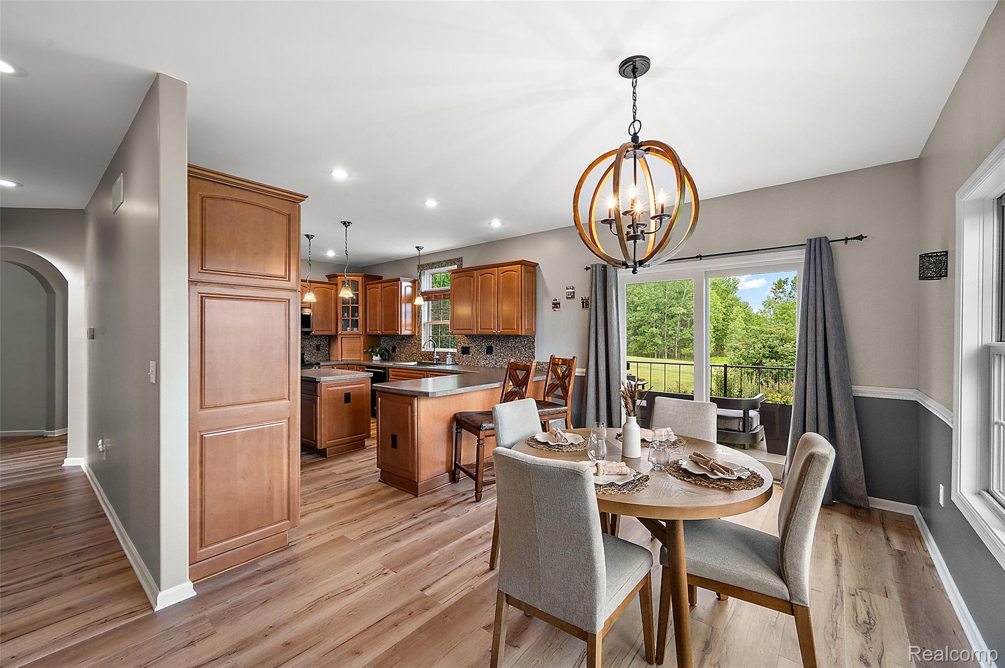 5035 Hidden Ridge Road Metamora, MI 48455 - Photo 15 of 65 Open-concept kitchen and dining area featuring wood-finish flooring, recessed lighting, and a sliding glass door leading to an outdoor space