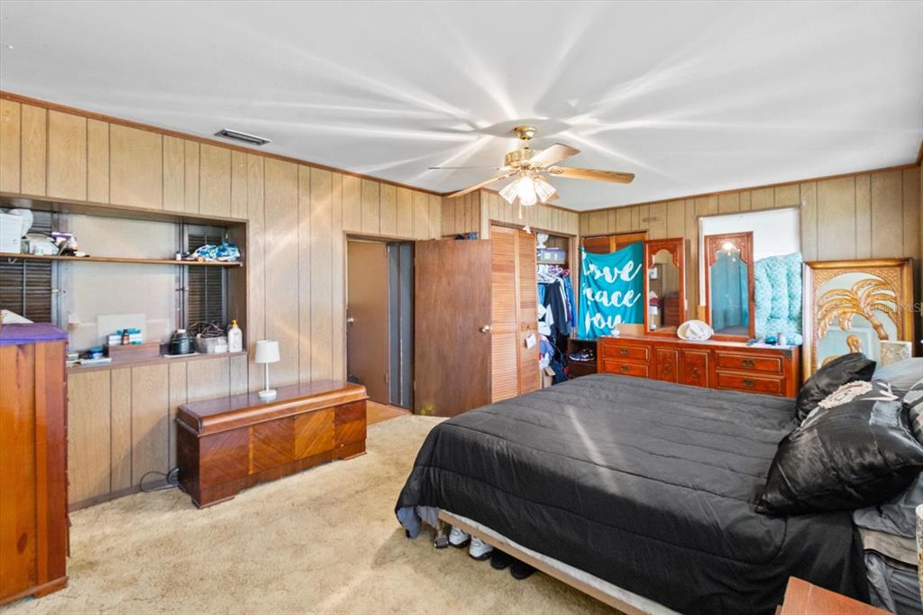 1226 South Telephone Point Road Inverness, FL 34450 - Photo 24 of 43 a bed room with a bed and a chandelier