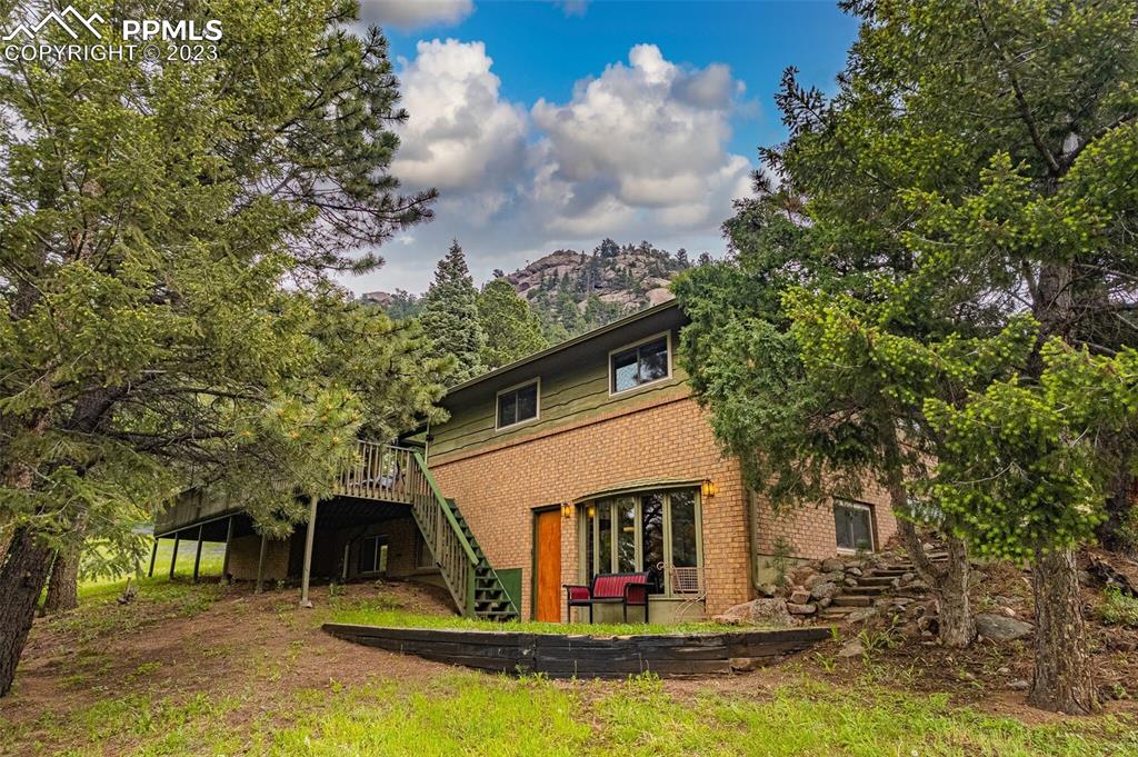a view of house with swimming pool