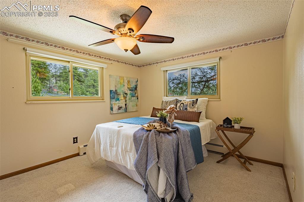 98 Button Rock Road Lyons, CO 80540 - Photo 14 of 49 a bed room with a bed and a chandelier