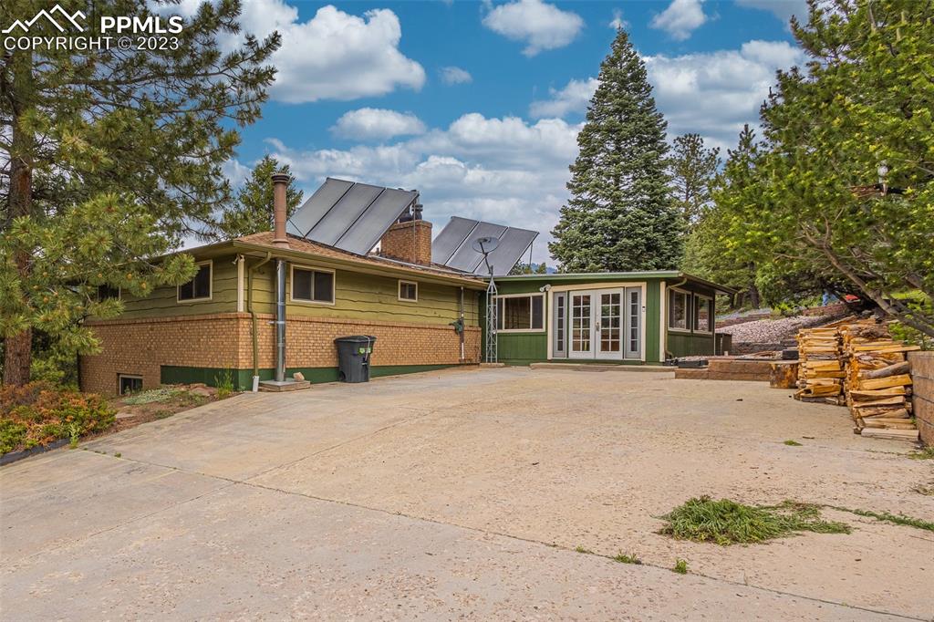 98 Button Rock Road Lyons, CO 80540 - Photo 2 of 49 a front view of a house with a yard and garage