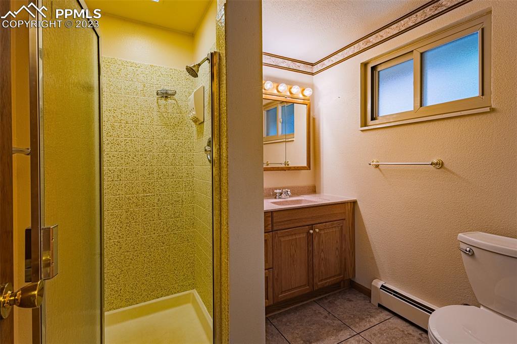 98 Button Rock Road Lyons, CO 80540 - Photo 23 of 49 a bathroom with a sink and mirror with toilet