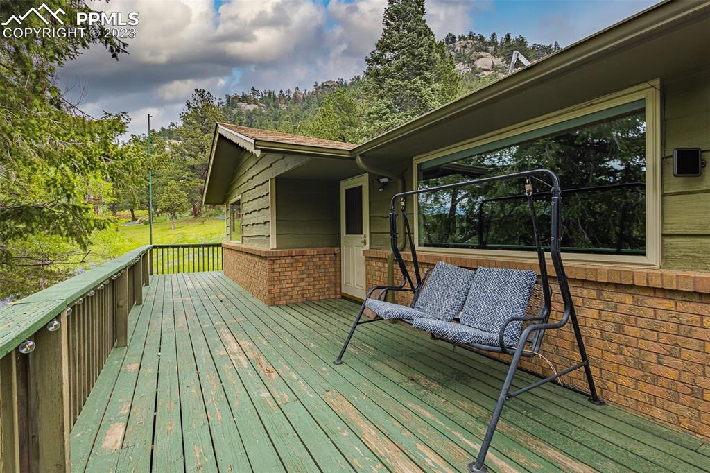 98 Button Rock Road Lyons, CO 80540 - Photo 26 of 49 a view of balcony with wooden floor and outdoor space