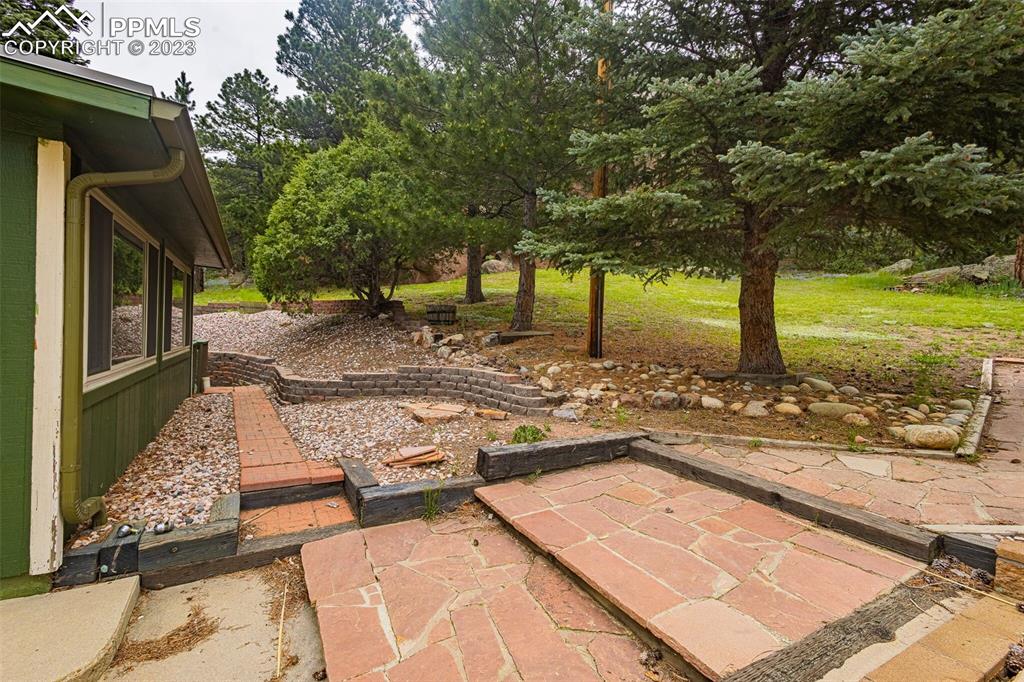98 Button Rock Road Lyons, CO 80540 - Photo 37 of 49 a view of a backyard with trees