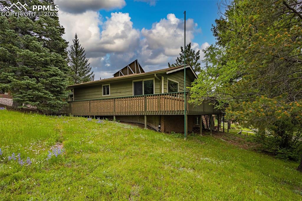 98 Button Rock Road Lyons, CO 80540 - Photo 41 of 49 a view of a house with a yard