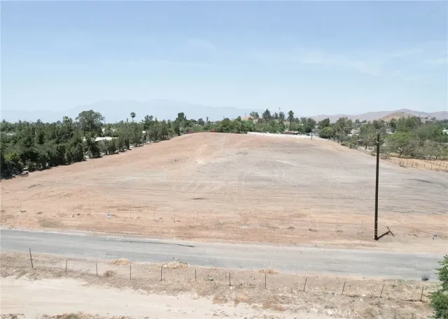 a view of a road and mountains in the background