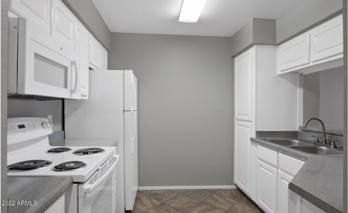 2025 East Campbell Avenue, Unit 238 Phoenix, AZ 85016 - Photo 4 of 18 a kitchen with stainless steel appliances granite countertop a sink stove and refrigerator