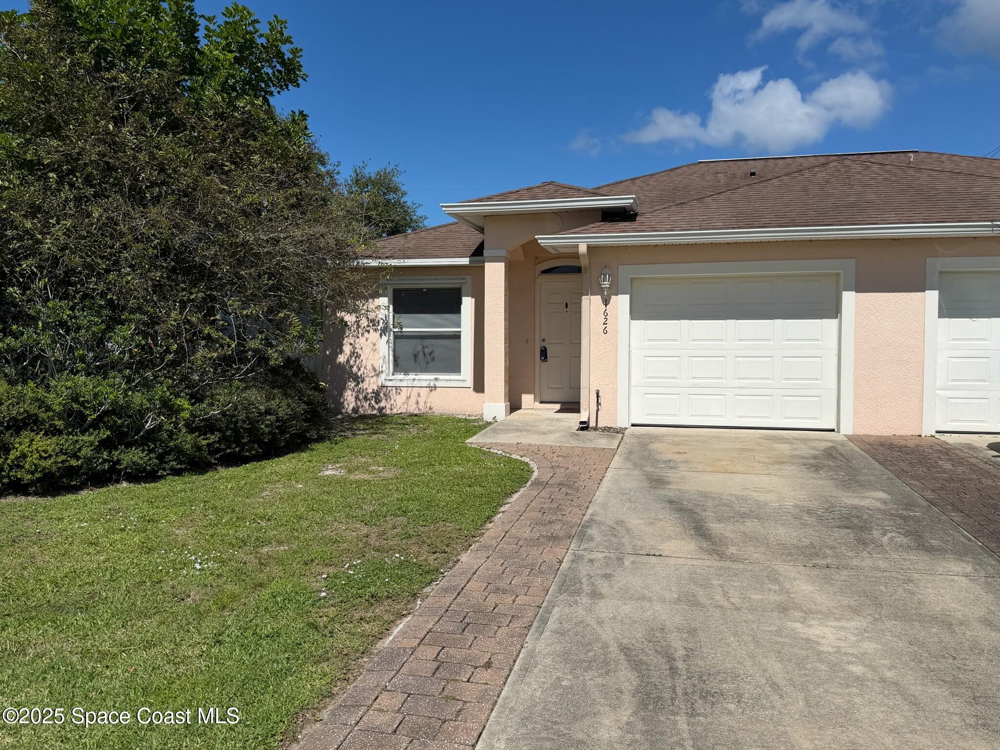 1626 Mason Terrace Melbourne, FL 32935 - Photo 1 of 24 a view of a house with a yard and garage