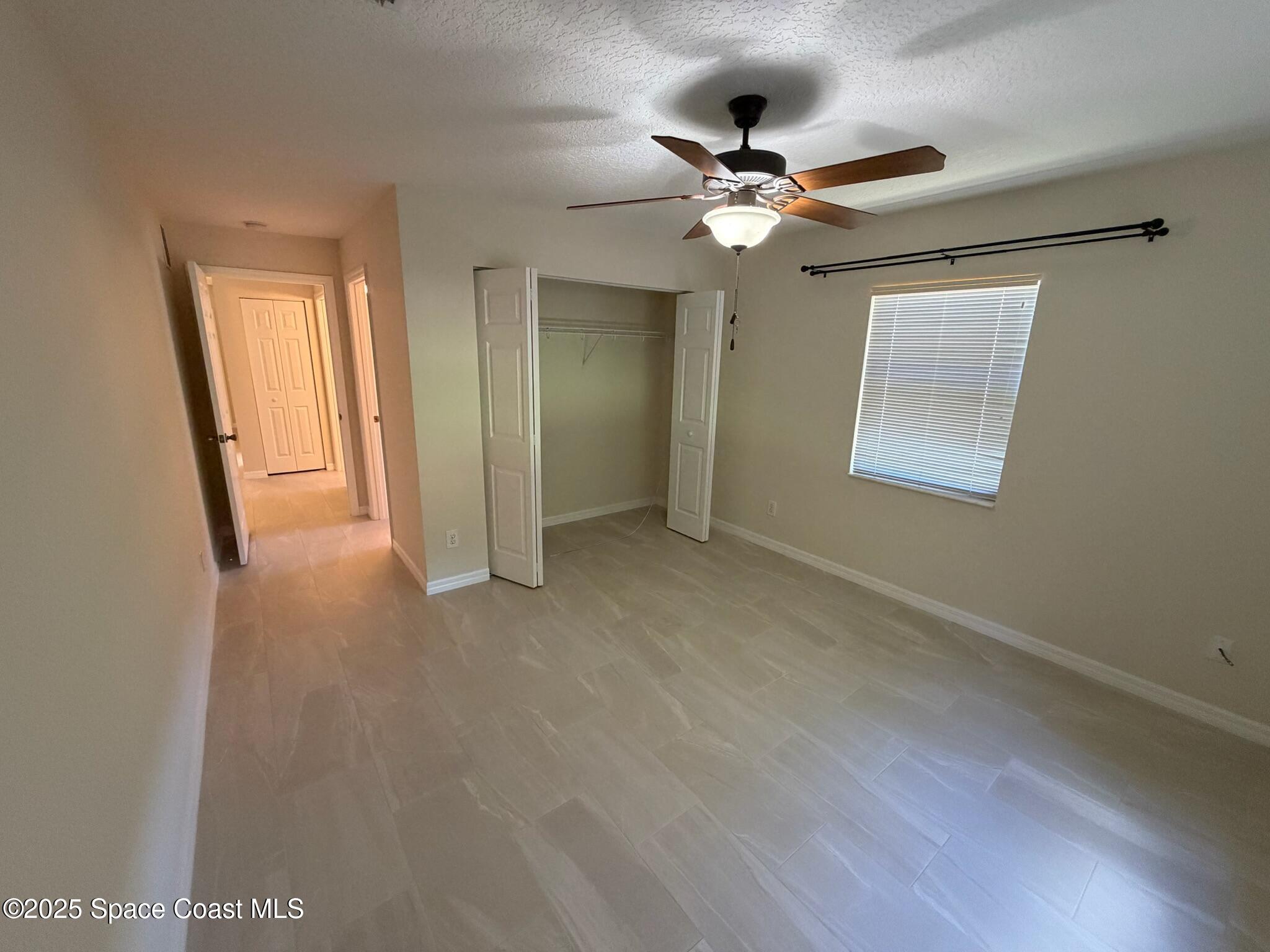 1626 Mason Terrace Melbourne, FL 32935 - Photo 11 of 24 a view of an empty room with a chandelier fan