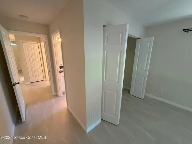 a view of a livingroom with a ceiling fan and window