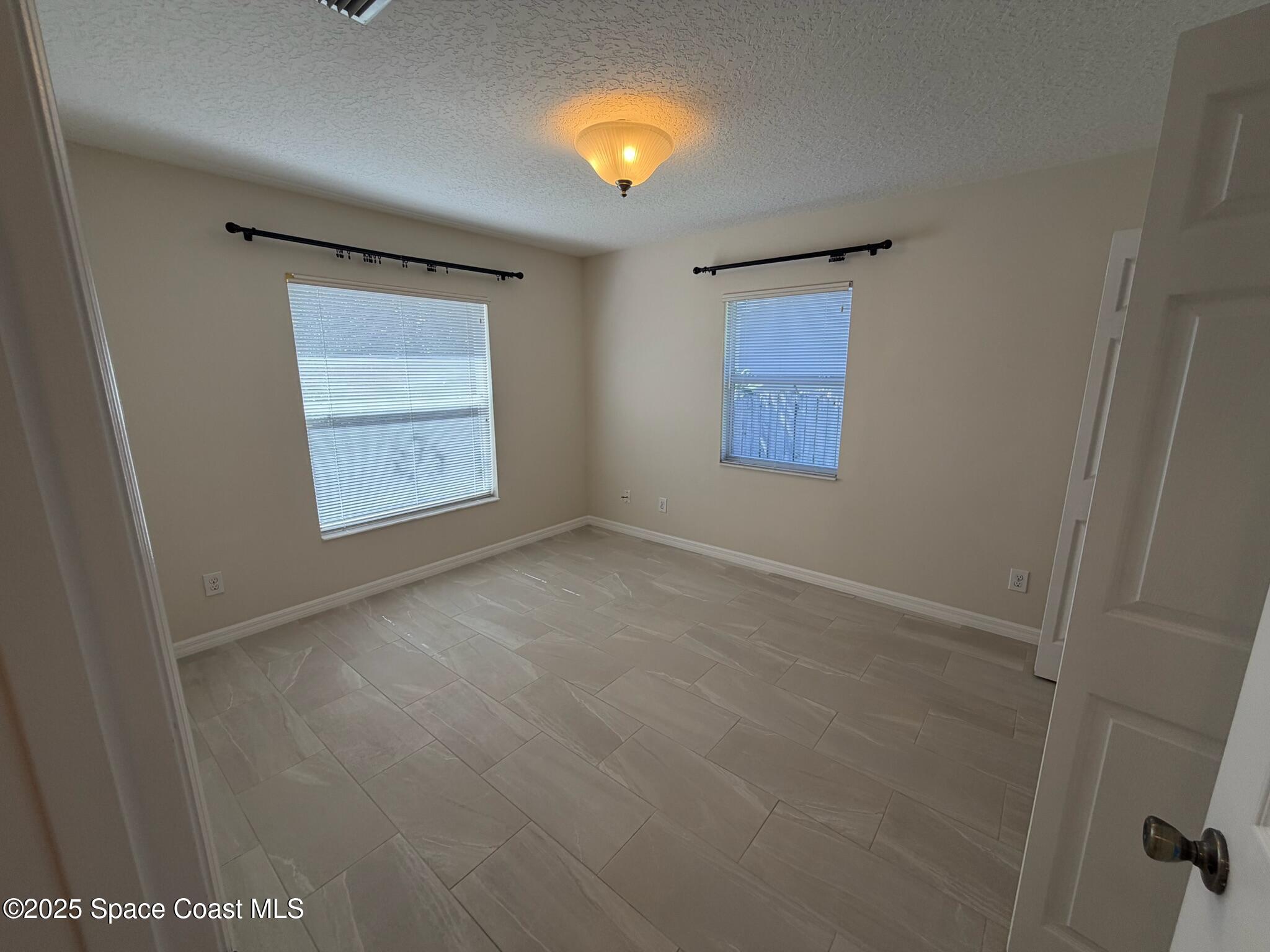 1626 Mason Terrace Melbourne, FL 32935 - Photo 16 of 24 an empty room with windows and closet