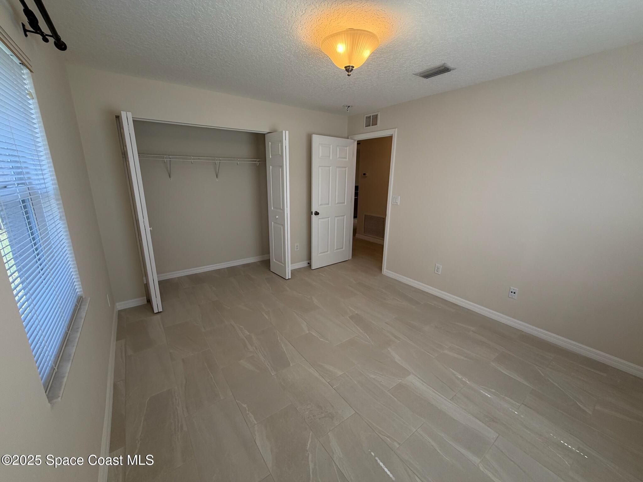 1626 Mason Terrace Melbourne, FL 32935 - Photo 17 of 24 a view of an empty room with a window