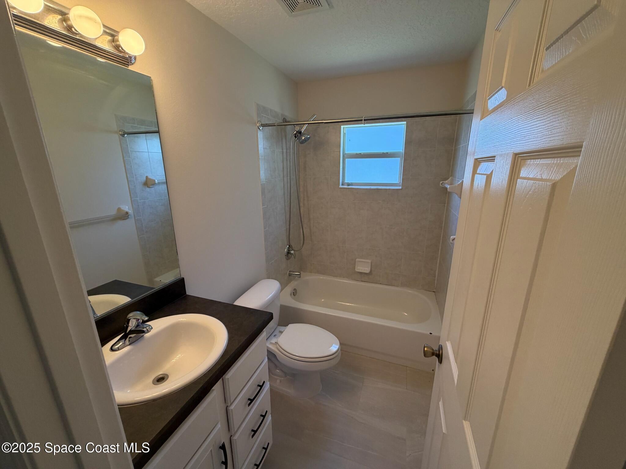 1626 Mason Terrace Melbourne, FL 32935 - Photo 18 of 24 a bathroom with a sink a toilet and shower