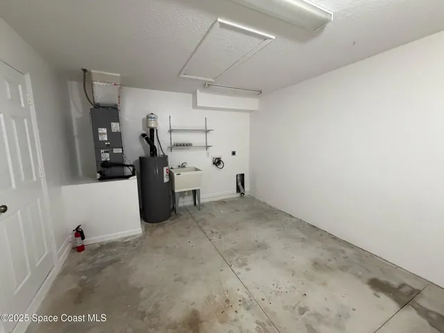 a view of a house with a large tree and a yard