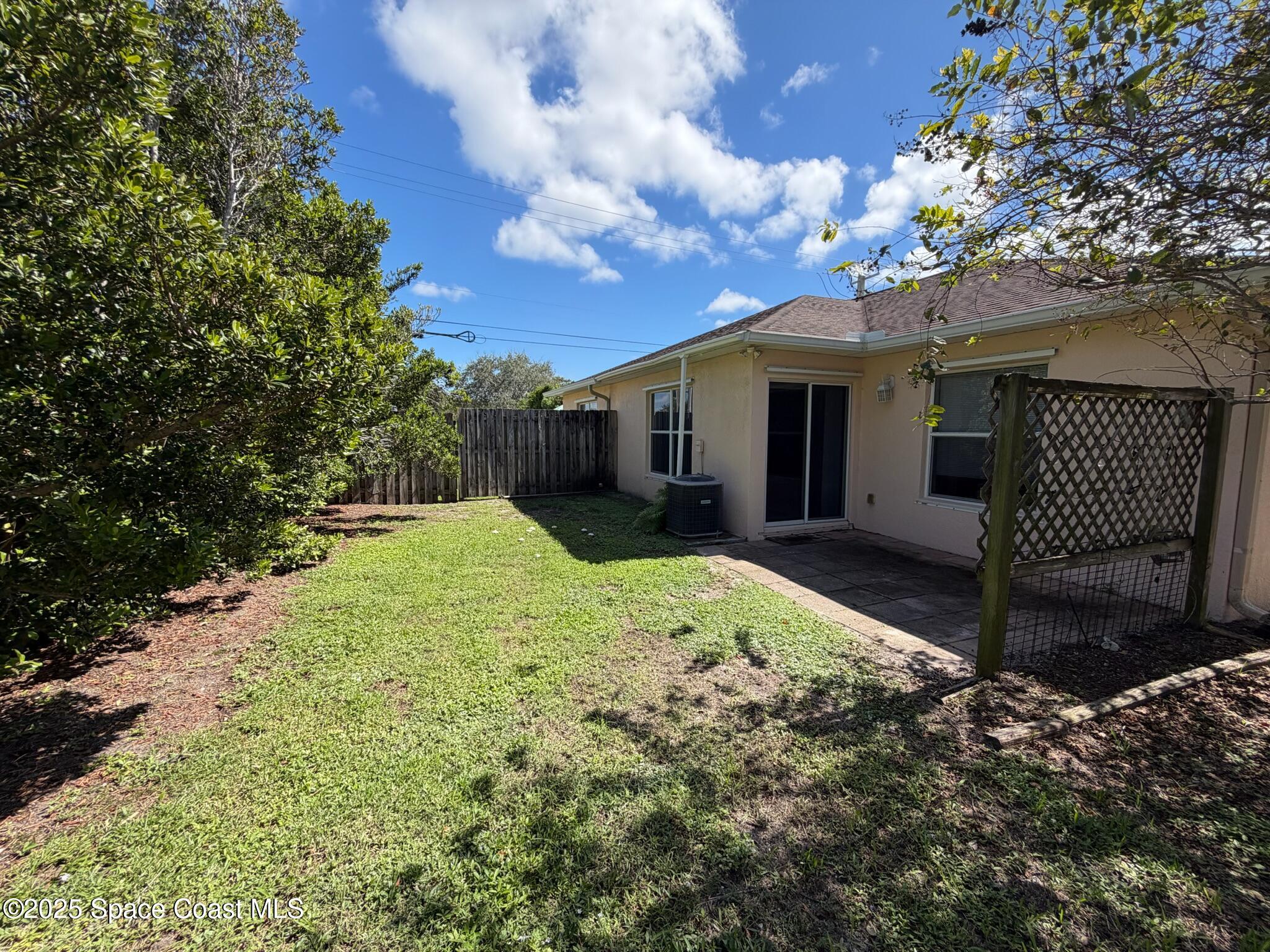 1626 Mason Terrace Melbourne, FL 32935 - Photo 21 of 24 a view of a house with a large tree and a yard