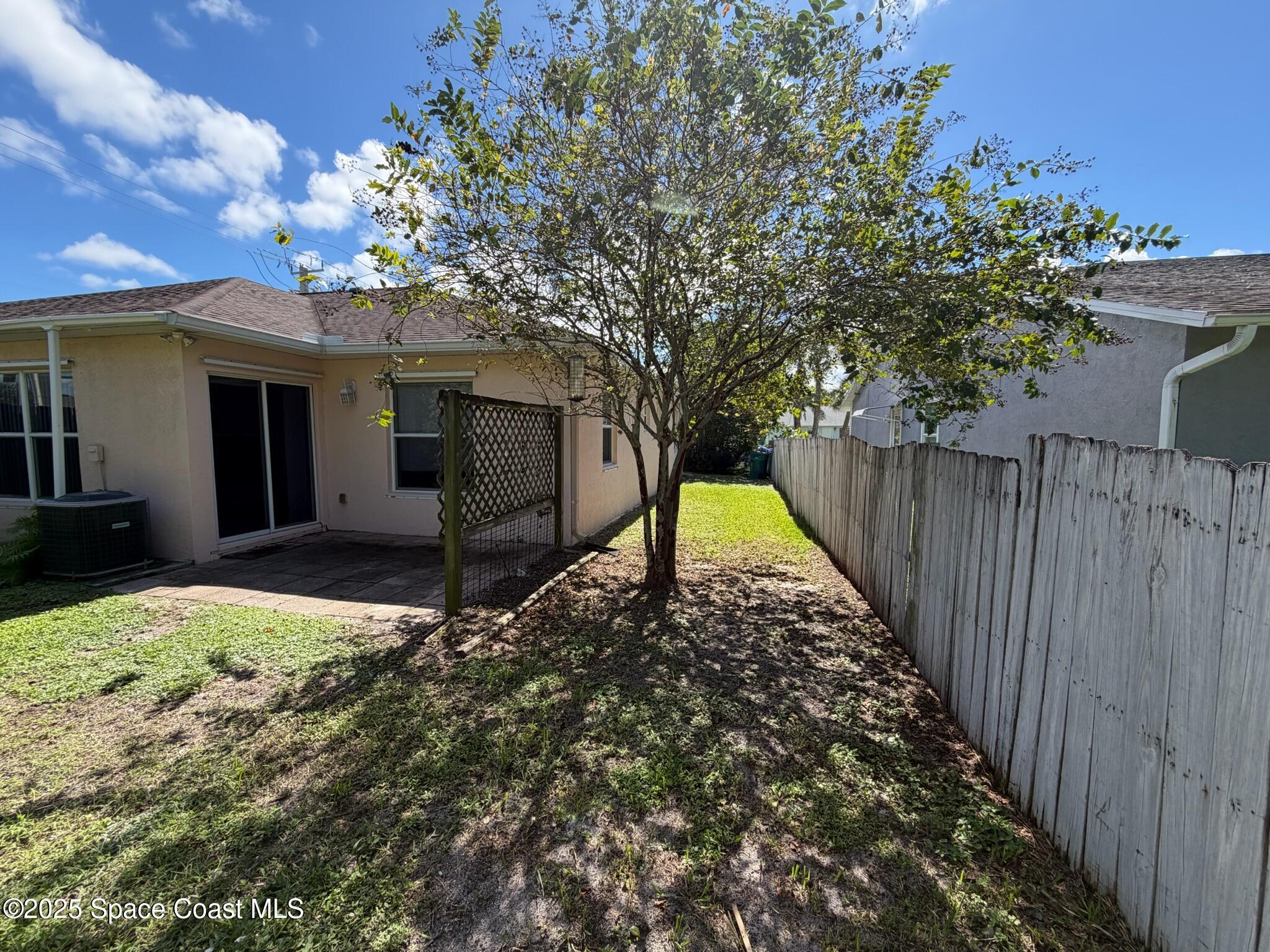 1626 Mason Terrace Melbourne, FL 32935 - Photo 22 of 24 a view of a house with a small yard and a large tree