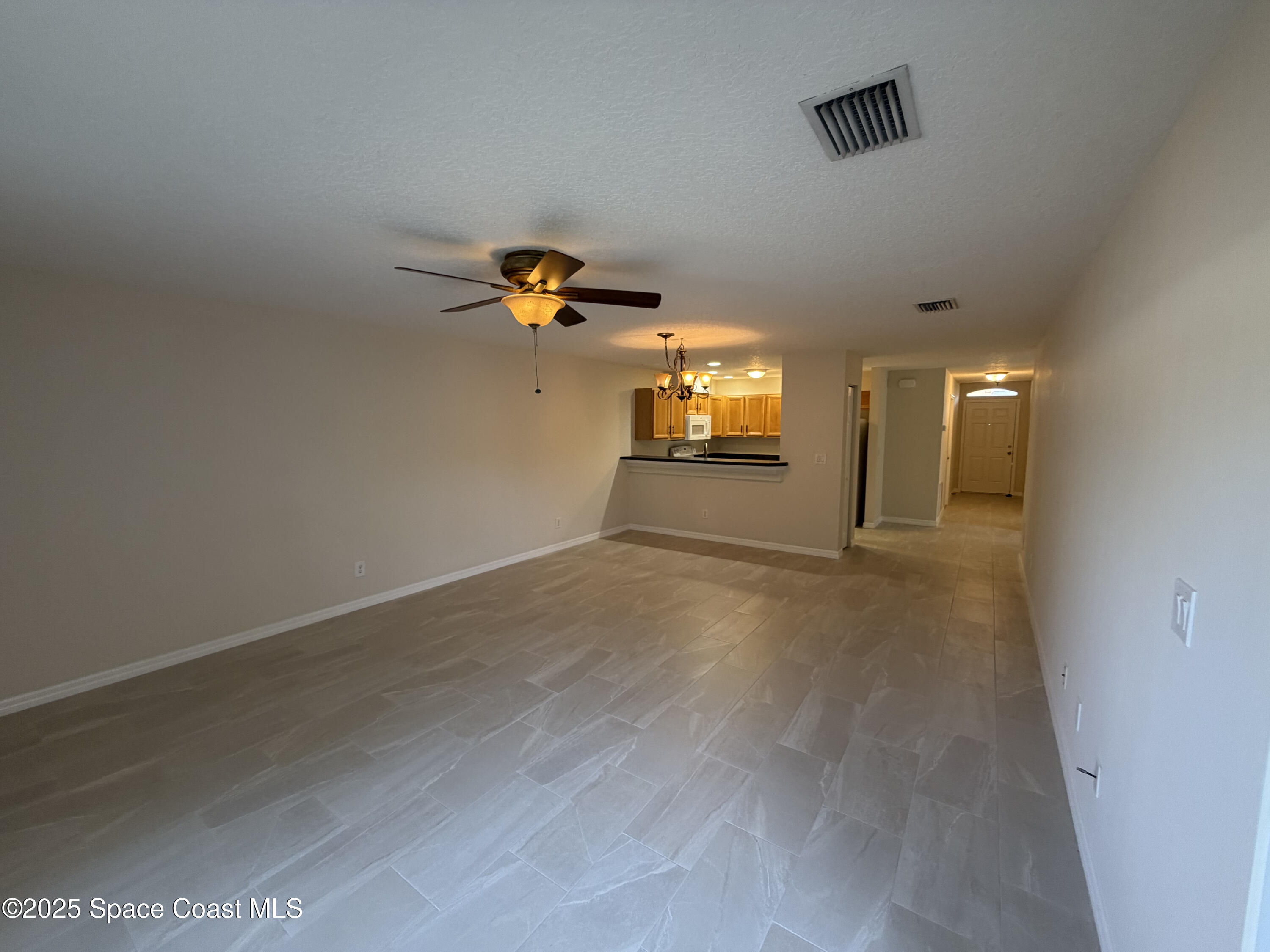 1626 Mason Terrace Melbourne, FL 32935 - Photo 9 of 24 wooden floor in an empty room with a window