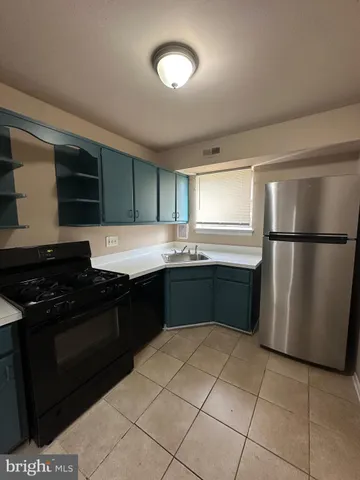 a kitchen with a refrigerator and a sink