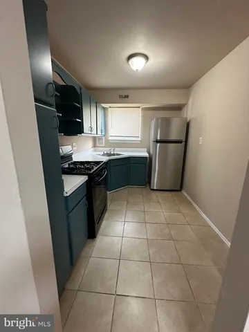 a kitchen with a stove and a refrigerator