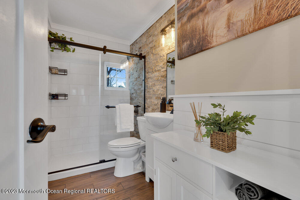 28 Pinehurst Road Brick, NJ 08723 - Photo 21 of 40 a bathroom with a shower curtain a toilet and a shower