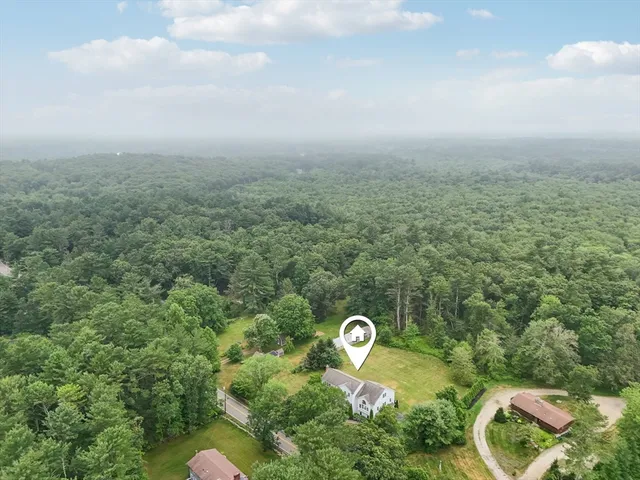 an aerial view of a house with a garden and swimming pool