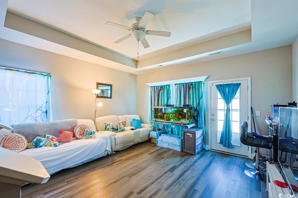 724 Hobonny Loop Longs, SC 29568 - Photo 3 of 40 Living area with a raised ceiling, wood finished floors, and a ceiling fan
