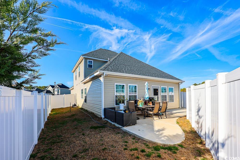 724 Hobonny Loop Longs, SC 29568 - Photo 34 of 40 Rear view of property featuring a patio area, a fenced backyard, and a shingled roof