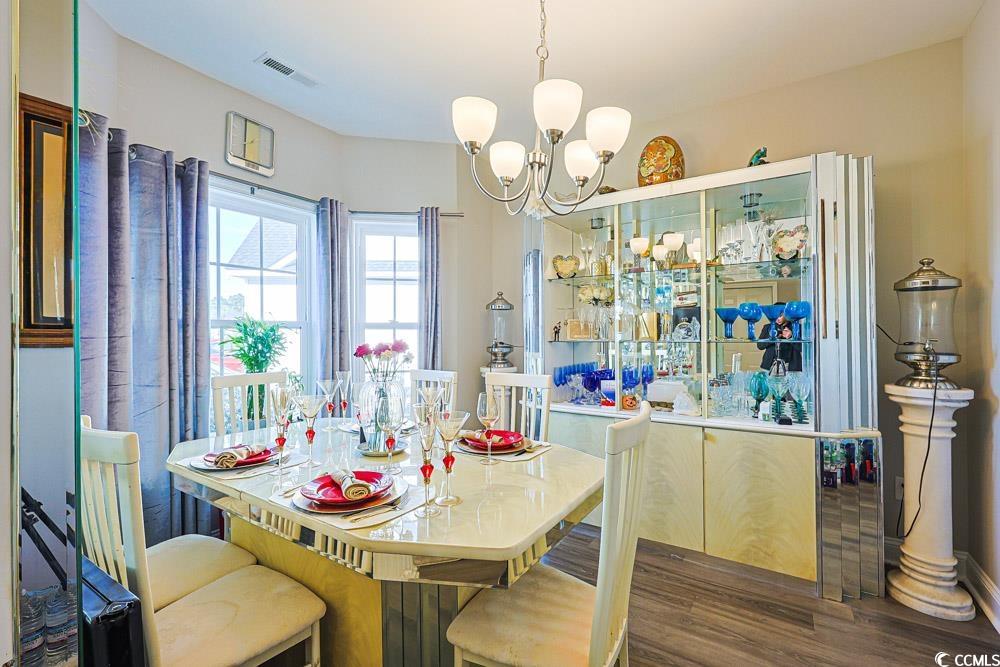 724 Hobonny Loop Longs, SC 29568 - Photo 9 of 40 Dining room featuring a chandelier and dark wood-style floors