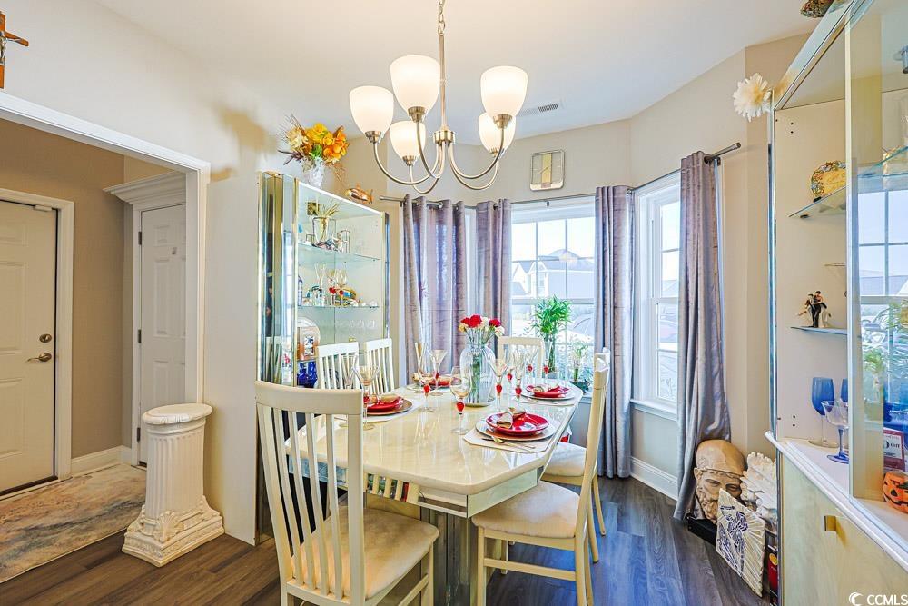 724 Hobonny Loop Longs, SC 29568 - Photo 10 of 40 Dining room with dark wood finished floors and a chandelier