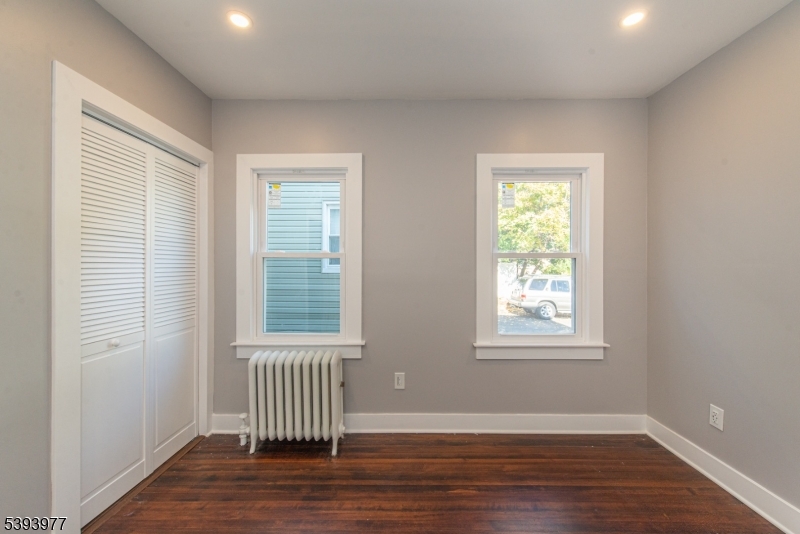 41 Elmwood Avenue, Unit 1 Montclair, NJ 07042 - Photo 11 of 18 an empty room with wooden floor and windows