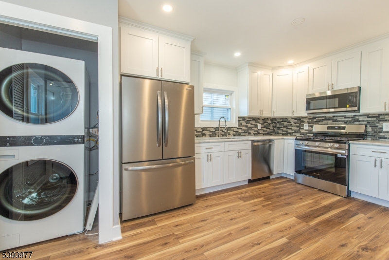 41 Elmwood Avenue, Unit 1 Montclair, NJ 07042 - Photo 15 of 18 a kitchen with a refrigerator sink and cabinets