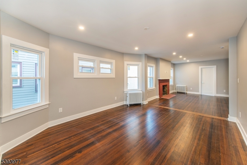 41 Elmwood Avenue, Unit 1 Montclair, NJ 07042 - Photo 4 of 18 a view of empty room with wooden floor and fan