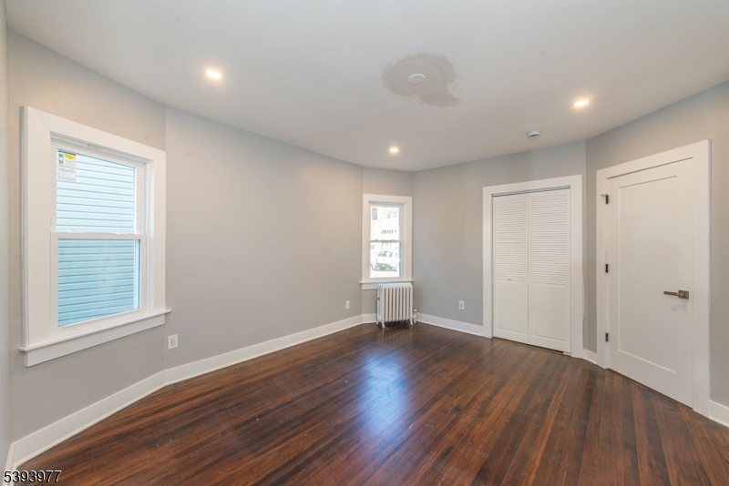 41 Elmwood Avenue, Unit 1 Montclair, NJ 07042 - Photo 7 of 18 a view of an empty room with wooden floor and a window