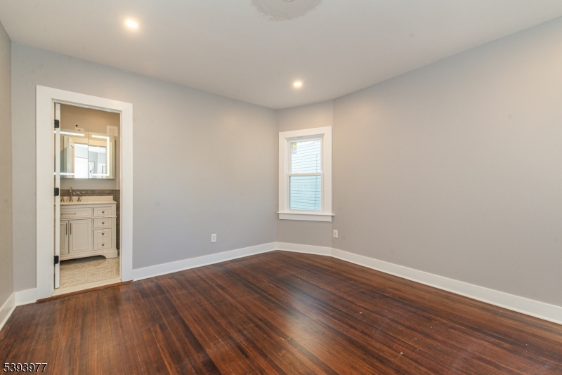 41 Elmwood Avenue, Unit 1 Montclair, NJ 07042 - Photo 8 of 18 wooden floor in an empty room with a window